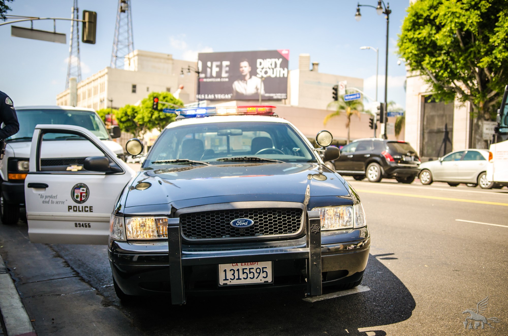 an LAPD squad car on the street with it's passenger side door open.