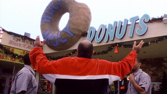 Moly (Maz Jabroni) shows off the majesty of Holy Moly Donuts. Photo via New Line Cinema.